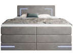 Vooraanzicht antraciet gestoffeerd bed met led-verlichting aan en op de topper een plaid en kussens.