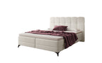 Cremekleurige boxspring met aubergine plaid en kussen
